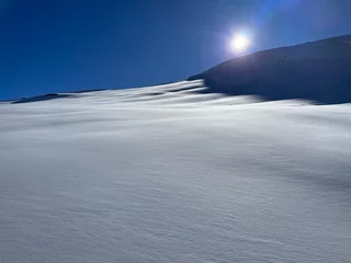 Fotobehang snowy mountain tops against dark blue ski from piz allalin saas fee valails wallis switzerland december 2023 © Soaps