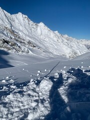 snowy mountain tops near glacier saas fee valais wallis in december, first snow, allalin glacier