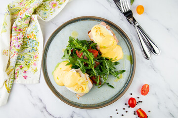 breakfast of arugula and tomato, toast with cheese and poached egg, top view