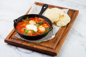 beetroot borscht with sour cream and parsley in a frying pan, side view