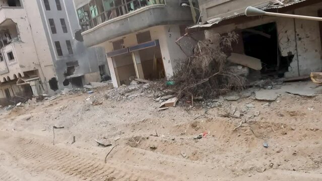 Perspective of an IDF Army jeep passing through the Gaza Strip, you can see buildings and houses completely destroyed by Israeli missile attacks