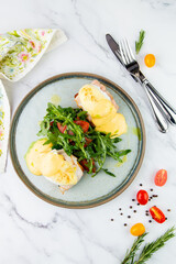 breakfast of arugula and tomato, toast with cheese and poached egg, top view