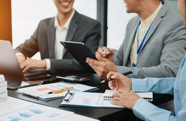 Fototapeta premium team business coworkers working on mobile laptop computer at office.Young woman holding tablet and pointing on touch screen. Horizontal, blurred background.Cropped..