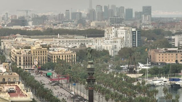 day time flight over barcelona city traffic street famous christopher columbus monument top aerial panorama 4k spain