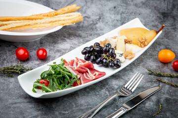 assorted fruits, grape nuts, bacon and arugula, top view