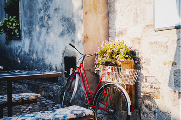 Retro bicycle with basket and flowers in a European city