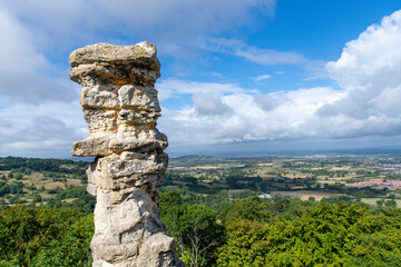Close up view of limestone rock formation Devil’s Chimney against backdrop of panoramic view from...