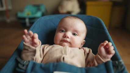 newborn baby in a rocking chair. happy family kid dream concept. portrait newborn baby boy child. son lifestyle boy baby lies in a rocking chair at home in a room indoors