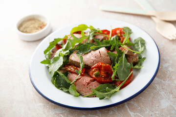 Arugula salad with roast beef and tomatoes