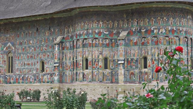 Colorful religious motifs painted on walls of Sucevita Monastery, UNESCO historical heritage in Bukovina, Romania