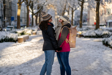 Female couple holding hands in beauiful winter landscape