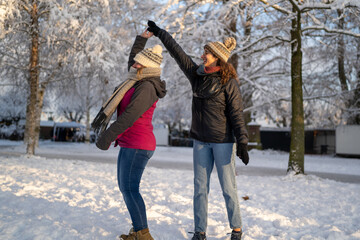 Winter Whirl: Female Friends Dancing and Spinning in Snowy Park Delight