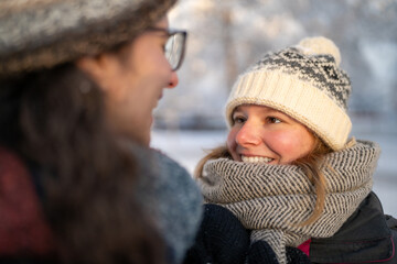 Loving Winter Moments: Female Couple's Intimate Gaze Amidst Snowy Serenity