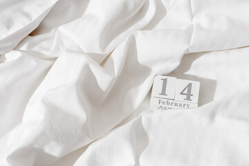 14 february background, holiday date on calendar in bed with white cotton sheets. Valentine's Day...