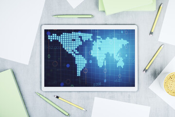 Top view of modern digital tablet monitor with abstract digital world map, research and strategy concept. 3D Rendering