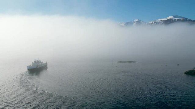 The car ferry MF "Haram" sails into thick fog between Dryna and Brattv&aring;g, just north of &Aring;lesund, Norway.