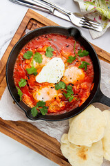 beetroot borscht with sour cream and parsley in a frying pan, side view