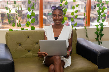 Relax african american lady enjoy her weekend, surfing on internet on laptop at home