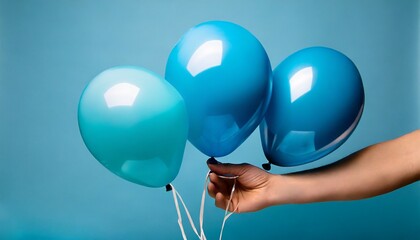 bright matte balloons on a blue background three blue inflated balloons stylish party with balloons round blue and balloon hand hold balloon isolated