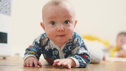 baby crawling. baby infant son makes the first move crawls on the floor for a toy. first steps happy family kid dream concept. son kid playing crawling in the room indoors at home