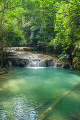 Erawan National Park in Thailand. Erawan Waterfall is a popular tourist destination and famous for its emerald blue water. Deep forest in tropical climate with fantasy atmosphere.