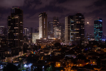 Tel Aviv modern office buildings at night. Full moon
