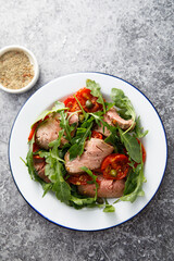 Arugula salad with roast beef and tomatoes