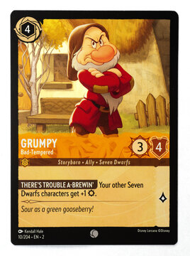 Hamburg, Germany - 10312023: macro photo of the English Ravensburger trading card called Grumpy Bad-Tempered from the Disney lorcana rise of the floodborn set on white paper background.