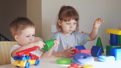 kindergarten. a group of children play toys cubes and cars on the table in kindergarten. kid dream creative happy family preschool education concept. nursery baby indoor toddler home