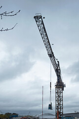Working crane silhouetted against a threatening sky in autumn UK