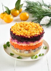 Christmas layered vegetable salad with herring and boiled vegetables
