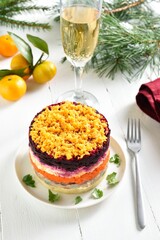 Christmas layered vegetable salad with herring and boiled vegetables 