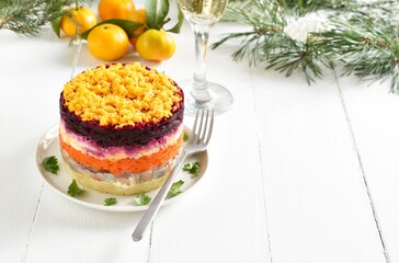 Christmas layered vegetable salad with herring and boiled vegetables