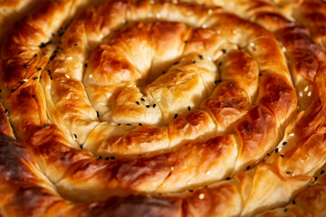 Traditional Turkish pastry with cheese.Turkish Tepsi Boregi, Round Borek, Tray pastry (Turkish name; rulo borek)