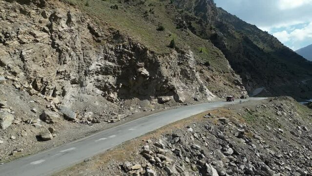 Aerial view of National Highway near Babusar Pass (13700ft) along with Kunhar river flowing and lush green fields on mountain slopes. Babusar pass connects Gilgit Baltistan with khyberpakhtunkhwa