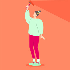 Simple image of a girl in bright sweater and leggings painting the walls in bright orange colour. Abstract girl doing home renovation