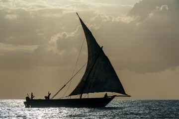 dhow traditional sailing vesssels of zanzibar tanzania at dusk viewed on a calm dusk evening 