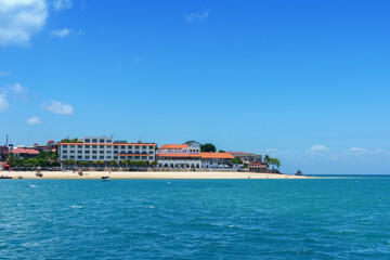 coastal view of the stone town seaboard showing the beach and shore-lined with hotels and buildings