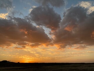 Sun shining through the clouds and the blue sky over the mountain
