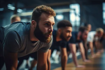 Foto op Plexiglas Group of sporty men in row workout together at gym. © Bojan