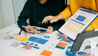  UX developer and ui designer brainstorming about mobile app interface wireframe design with...