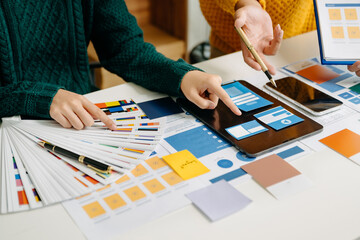  UX developer and ui designer brainstorming about mobile app interface wireframe design with...
