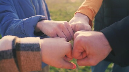 Fototapeta premium close-up fists a join together team. business team teamwork concept. close-up hands fists together group of people. team of young lifestyle tourists fists together success business concept
