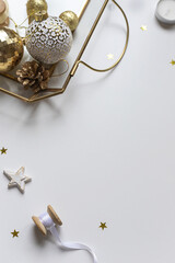 Christmas celebration concept frame with golden and white decoration on the table. Copy space