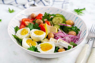 Breakfast. Greek salad and boiled eggs. Fresh vegetable salad with tomato, cucumbers, olives, arugula and cheese.