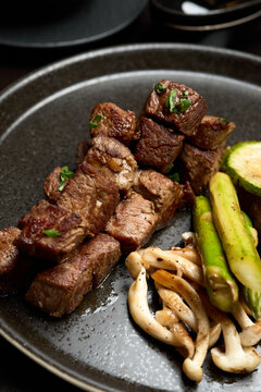 Grilled Beef Steak with Fried Potato, Asparagus, Avocado and Mushrooms