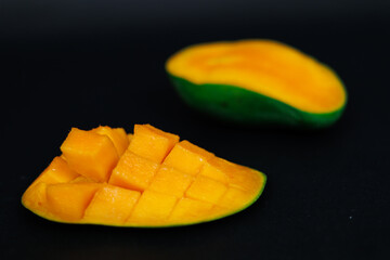 mango harumanis slice isolated on black. selective focus. shallow depth of field.