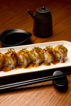 Sushi rolls with eel and teriyaki sauce, close-up.