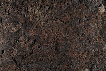 Brown stone texture, dark abstract background. Natural mineral rock close up details, empty backdrop with copy space for design