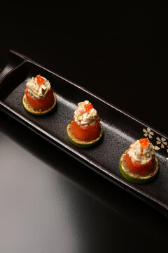 Sushi rolls with salmon, lime, red caviar, close-up